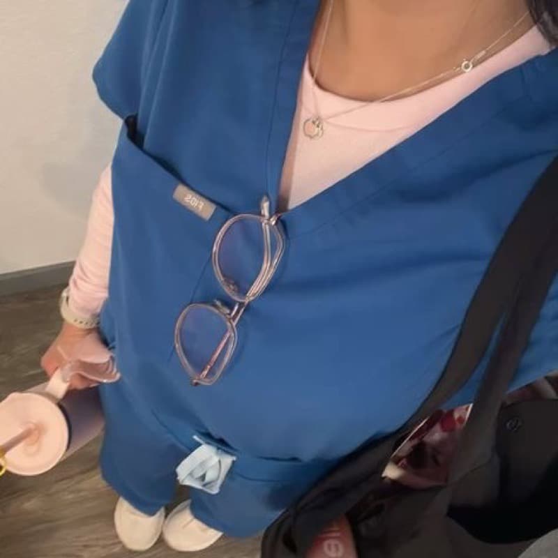 Nursing student in blue scrubs heading to a clinical rotation
